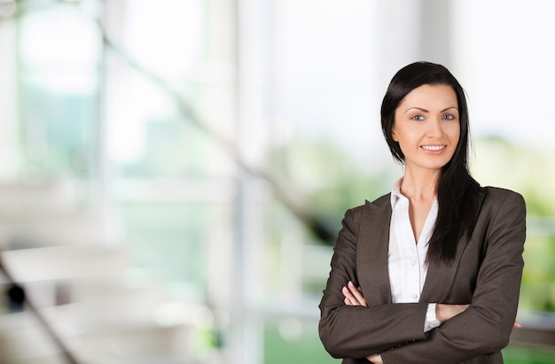 Young businesswoman in suit on blurred background