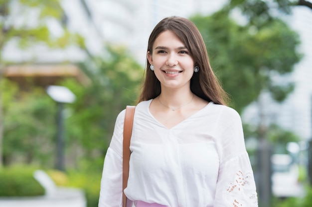 Young businesswoman walking outdoors