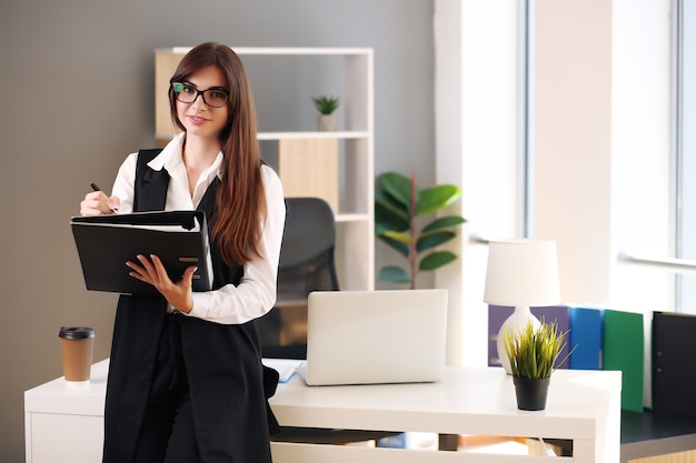 Young businesswoman working in her office