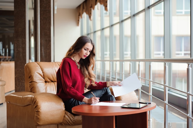 Young businesswoman working on laptop while waiting for her flig