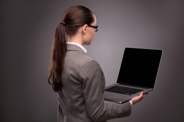 Young businesswoman working with laptop in business concept