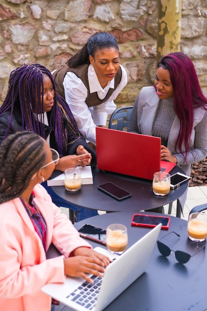 Young businesswomen of black ethnicity. At a business meeting in a cafeteria with computers