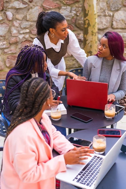 Young businesswomen of black ethnicity. At a business meeting in a cafeteria