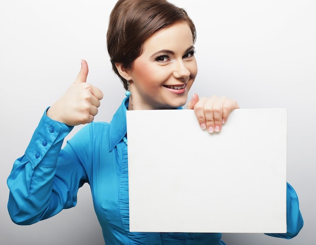 Young casual woman happy holding blank sign, happy time