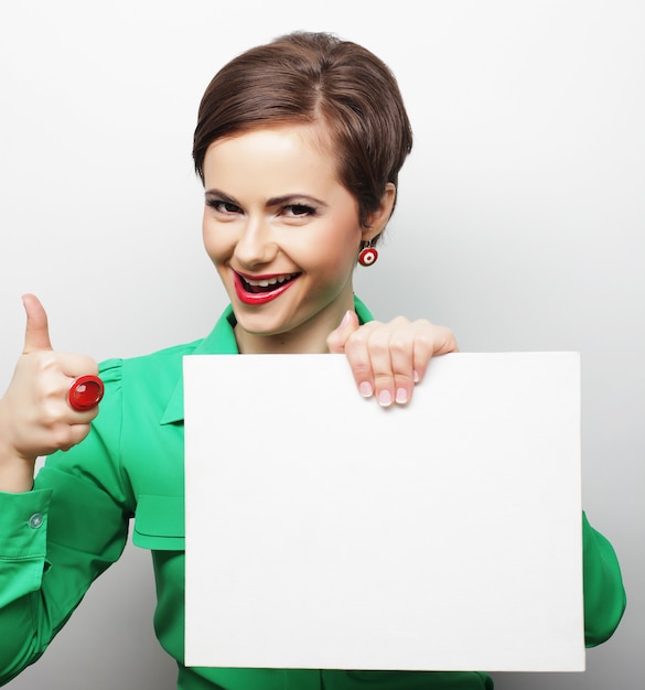 Young casual woman happy holding blank sign, happy time