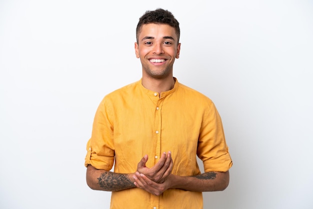 Young caucasian Brazilian man isolated on white background laughing