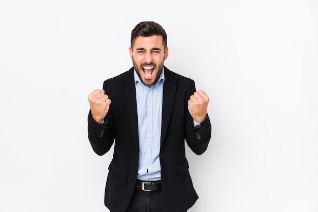 Young caucasian business man cheering carefree and excited. Victory concept.