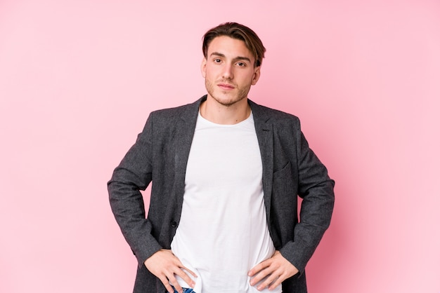 Young caucasian business man posing isolated confident keeping hands on hips.