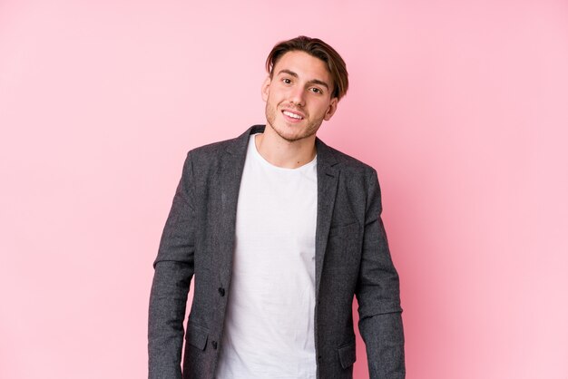 Young caucasian business man posing isolated happy, smiling and cheerful.