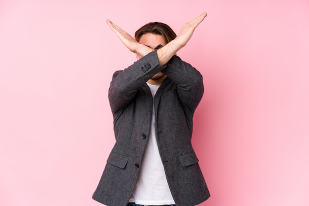 Young caucasian business man posing isolated keeping two arms crossed, denial concept.