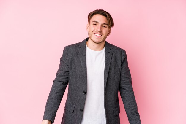 Young caucasian business man posing isolated laughs and closes eyes, feels relaxed and happy.