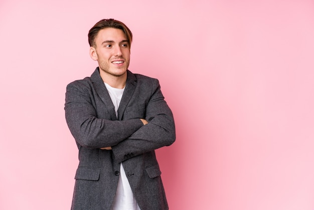 Young caucasian business man posing isolated smiling confident with crossed arms.