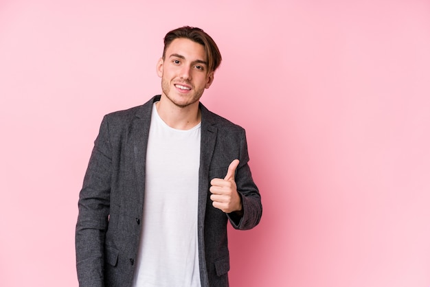 Young caucasian business man posing isolated smiling and raising thumb up