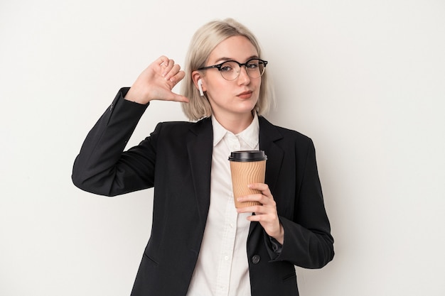 Young caucasian business woman holding take away coffee isolated on white background feels proud and self confident, example to follow.