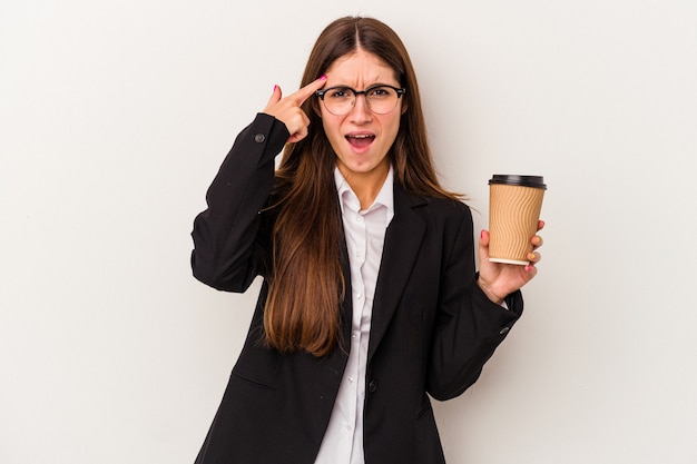 Young caucasian business woman holding a takeaway coffee isolated on white background showing a disappointment gesture with forefinger.