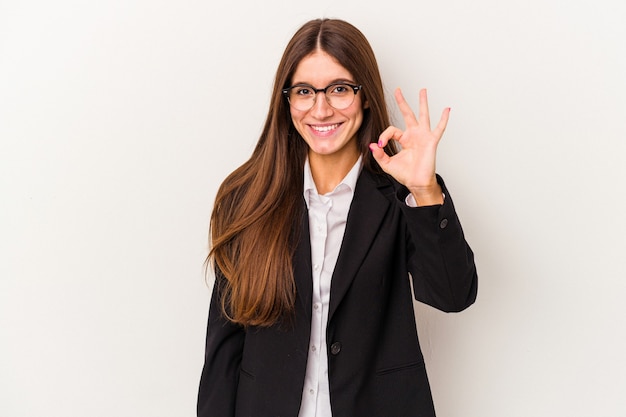 Young caucasian business woman isolated on white background cheerful and confident showing ok gesture.