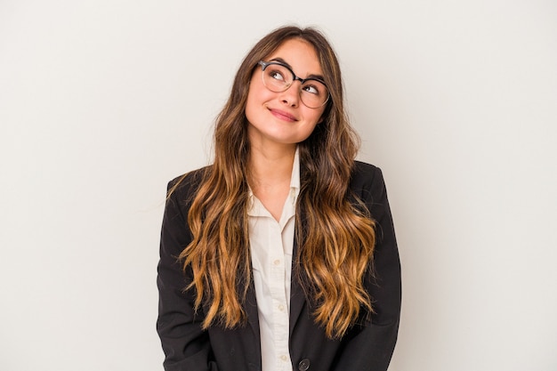 Young caucasian business woman isolated on white background dreaming of achieving goals and purposes