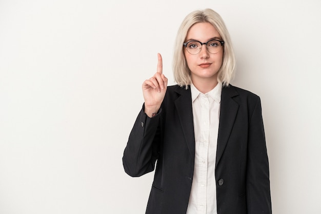 Young caucasian business woman isolated on white background showing number one with finger.