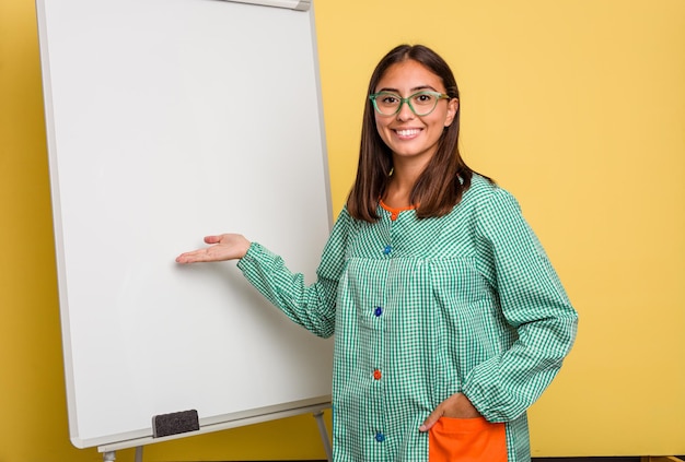 Young caucasian child education teacher explaining on the blackboard isolated