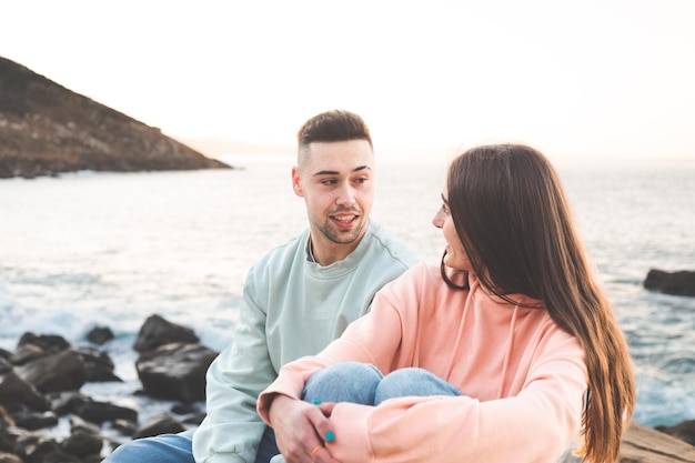 Young caucasian couple chatting at the sea side