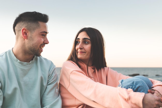 Young caucasian couple chatting at the sea side