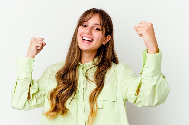 Young caucasian cute woman isolated on white cheering carefree and excited. Victory concept.