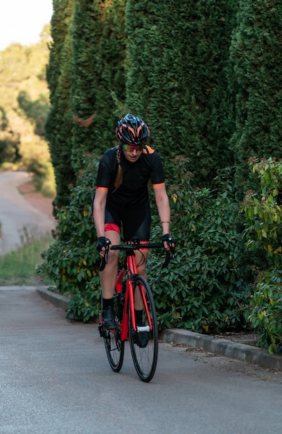 Young Caucasian cyclist riding a bicycle standing upright