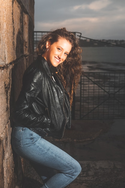 Young caucasian girl posing at a sea port.