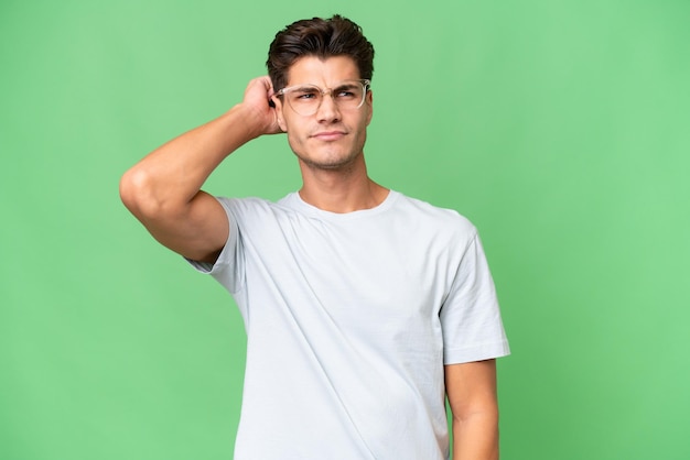 Young caucasian handsome man over isolated background having doubts