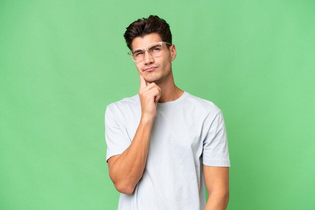 Young caucasian handsome man over isolated background and thinking