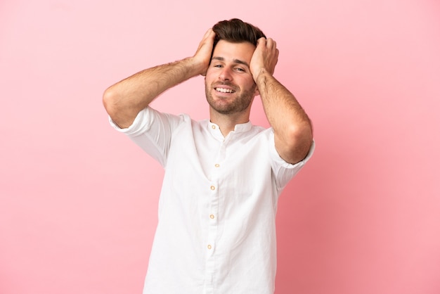 Young caucasian handsome man isolated on pink background laughing