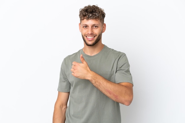 Young caucasian handsome man isolated on white background giving a thumbs up gesture