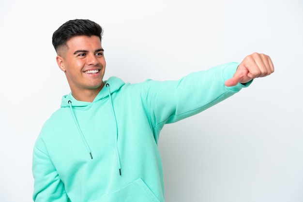 Young caucasian handsome man isolated on white background giving a thumbs up gesture