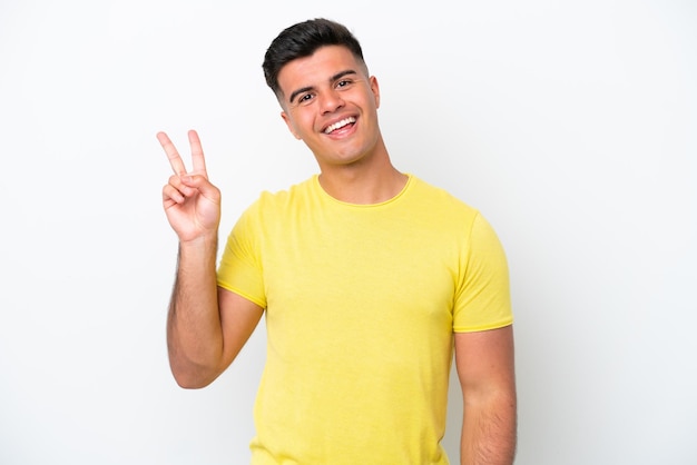 Young caucasian handsome man isolated on white background smiling and showing victory sign