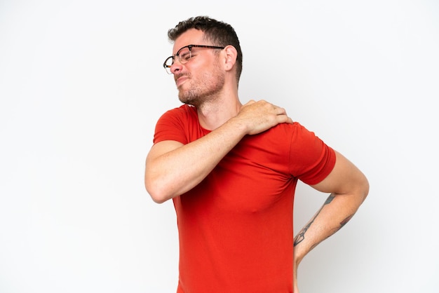 Young caucasian handsome man isolated on white background suffering from pain in shoulder for having made an effort