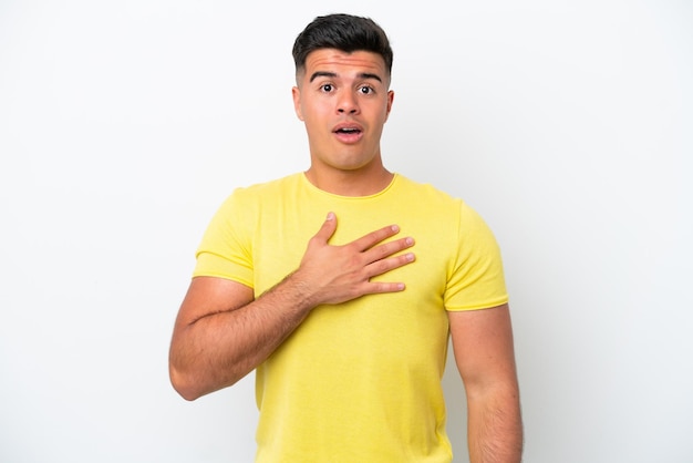 Young caucasian handsome man isolated on white background surprised and shocked while looking right