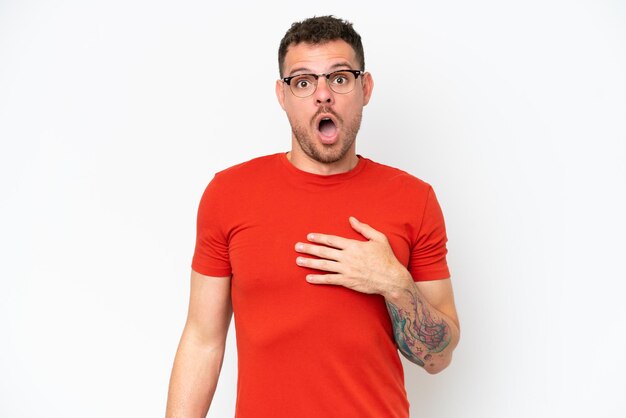 Young caucasian handsome man isolated on white background surprised and shocked while looking right