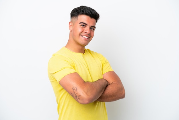 Young caucasian handsome man isolated on white background with arms crossed and looking forward