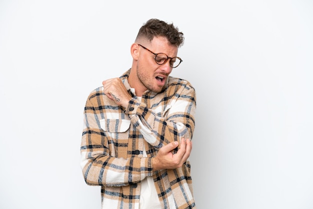 Young caucasian handsome man isolated on white background with pain in elbow