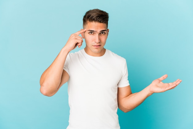 Young caucasian handsome man showing a disappointment gesture with forefinger.