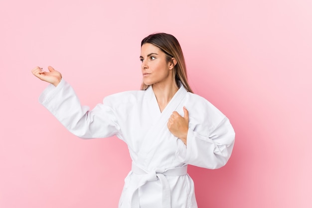 Young caucasian karate woman isolated