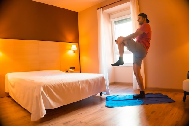 A young Caucasian man doing sports at home in isolation