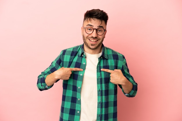 Young caucasian man isolated on pink background with surprise facial expression