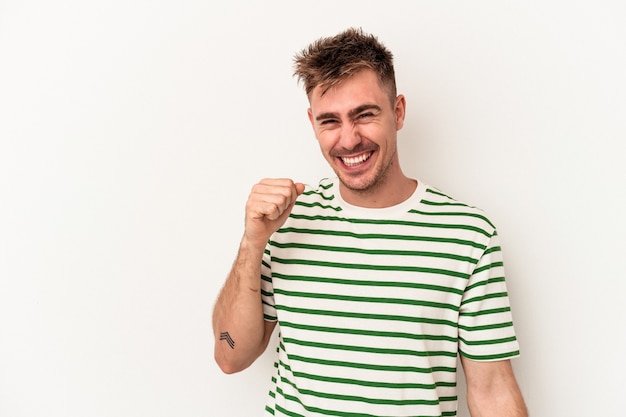 Young caucasian man isolated on white background dancing and having fun.