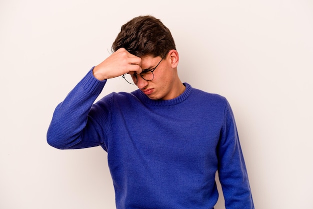 Young caucasian man isolated on white background having a head ache touching front of the face