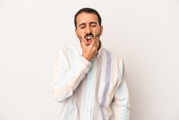 Young caucasian man isolated on white background having a strong teeth pain molar ache