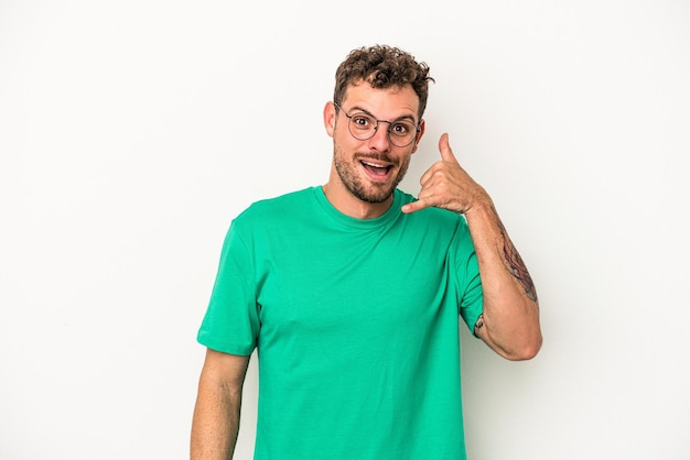 Young caucasian man isolated on white background laughing about something, covering mouth with hands.