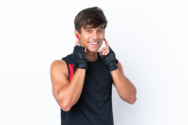 Young caucasian man isolated on white background listening music