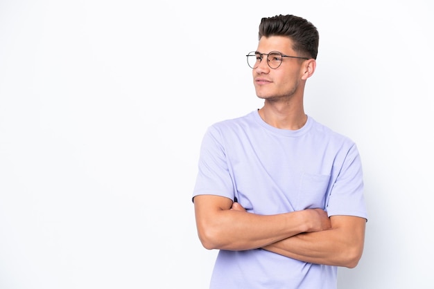 Young caucasian man isolated on white background looking to the side