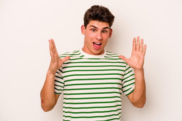 Young caucasian man isolated on white background screaming to the sky looking up frustrated